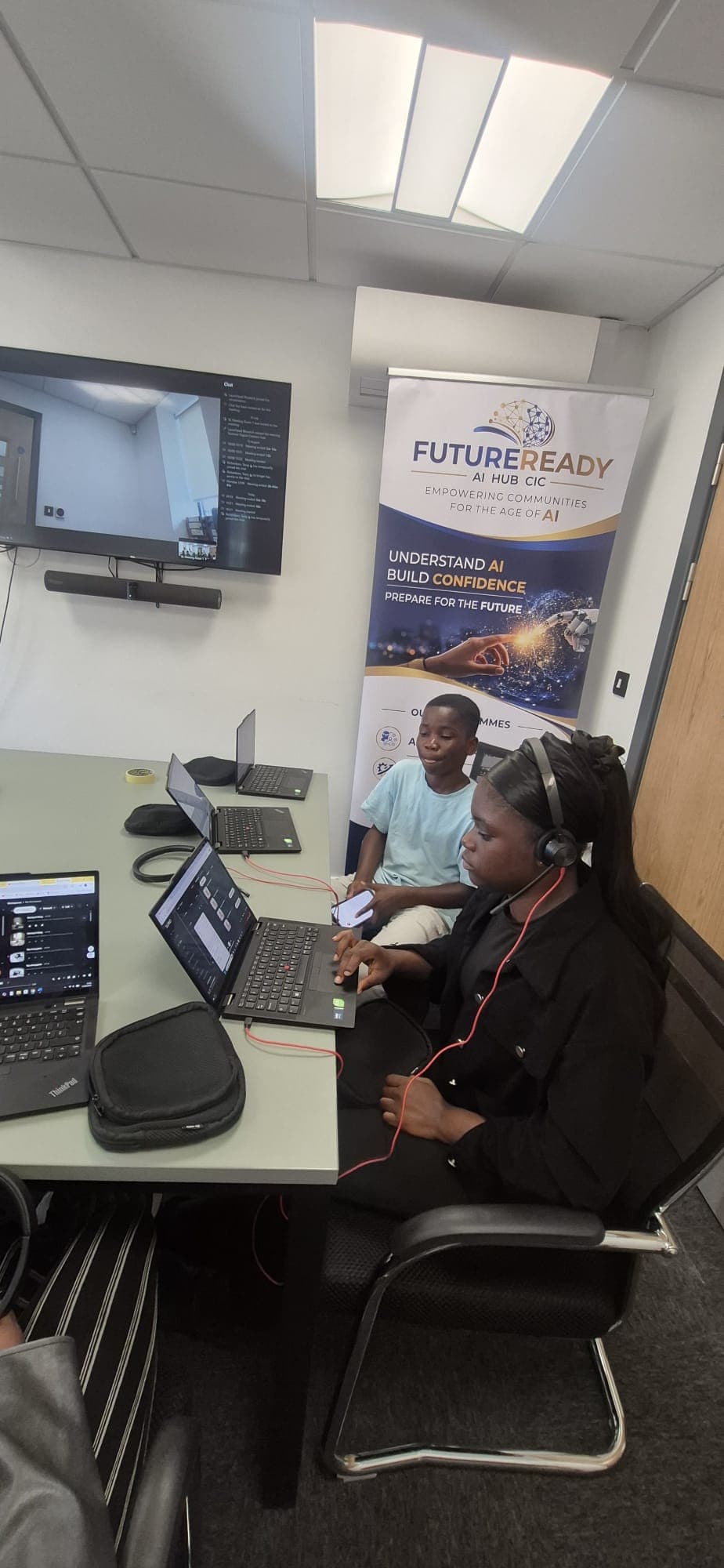 Two participants working on audio editing software during the AI music session