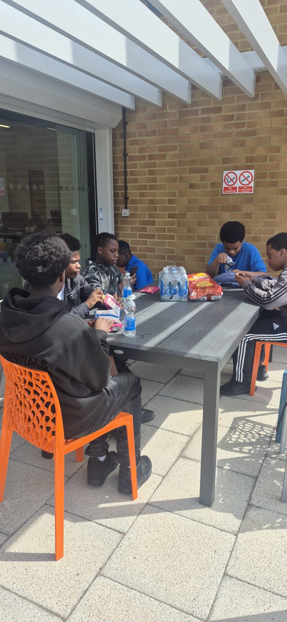 Participants taking a break together outside between workshop sessions