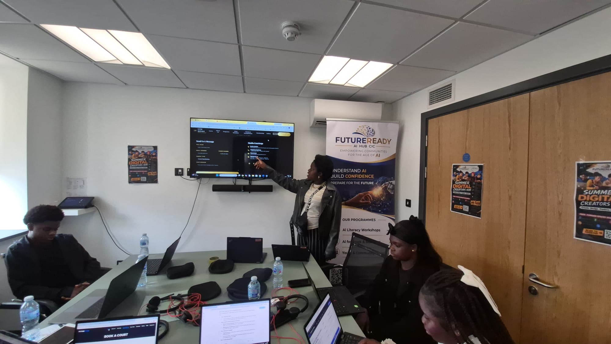 A trainer walking the group through a booking website built during the session