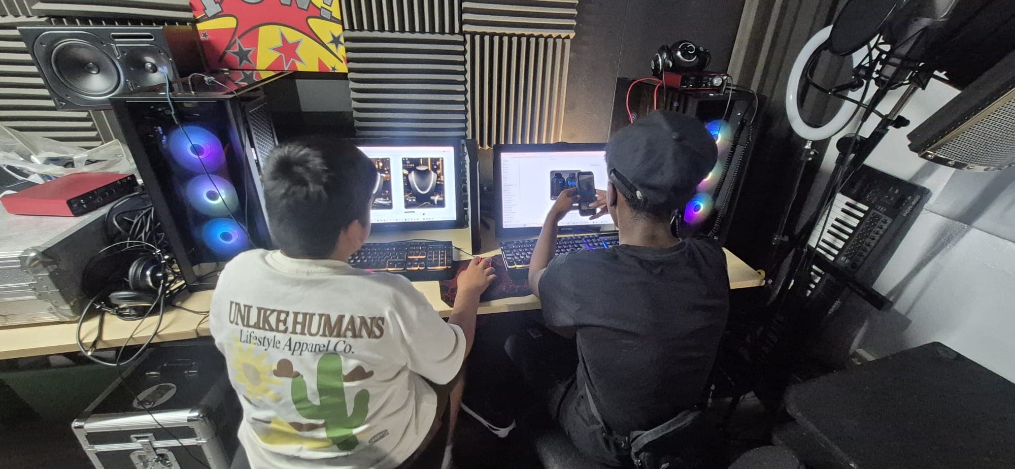 Two participants designing a jewellery brand on a studio workstation