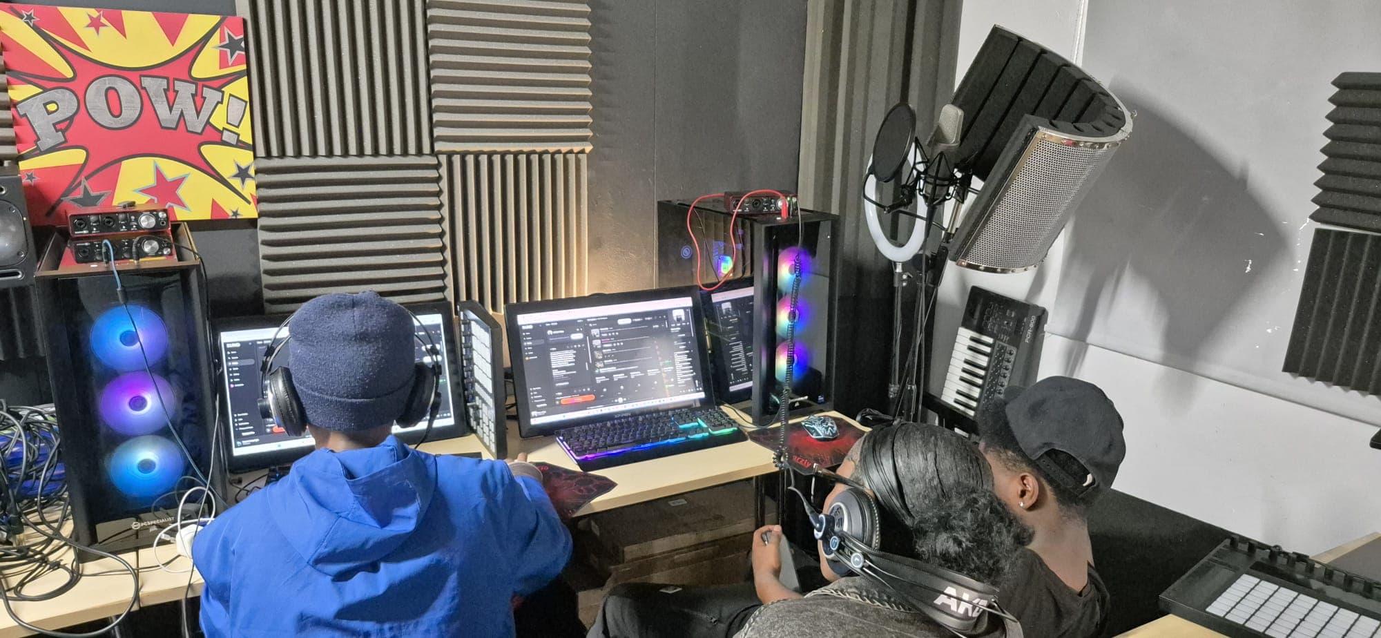 Participants producing a track together in the recording studio