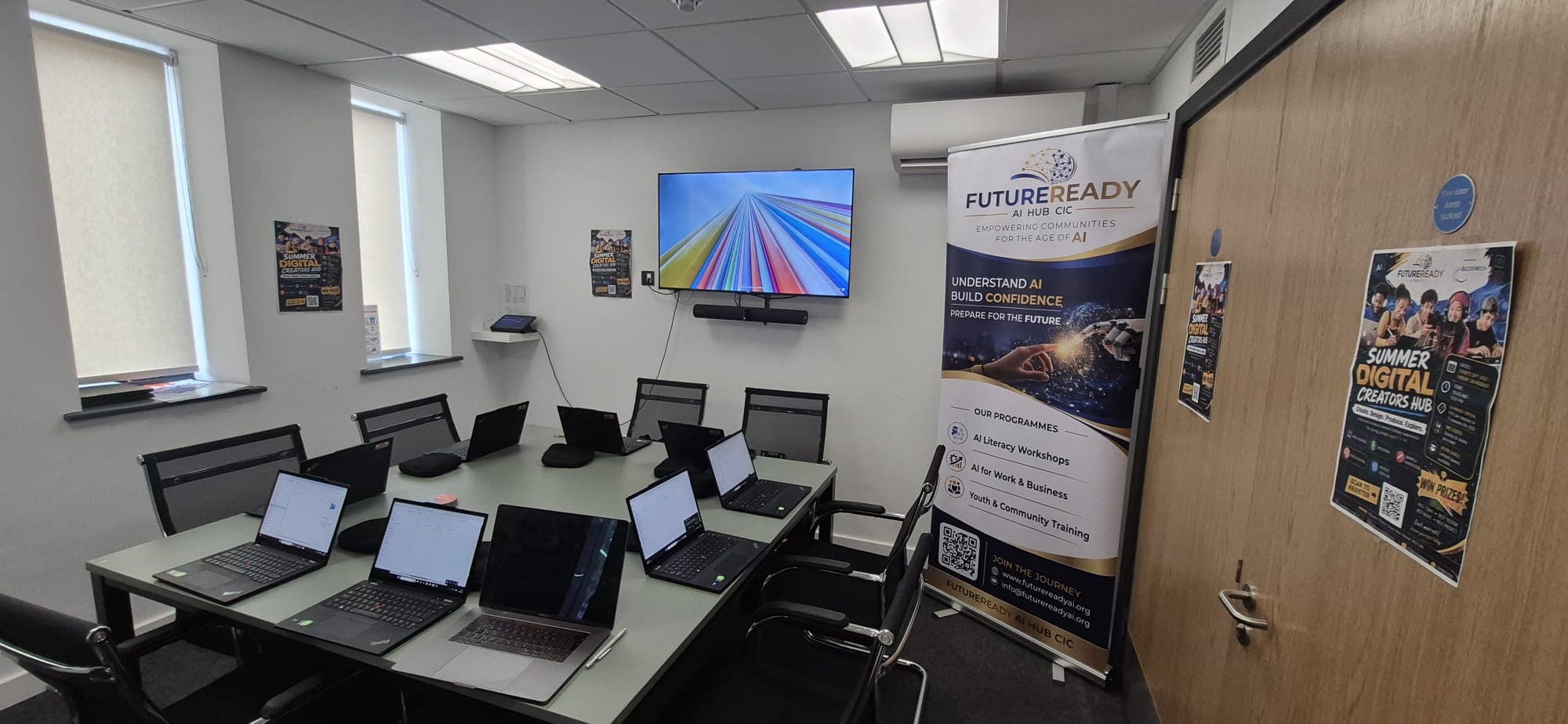 The digital hub set up with laptops ready for a workshop to begin