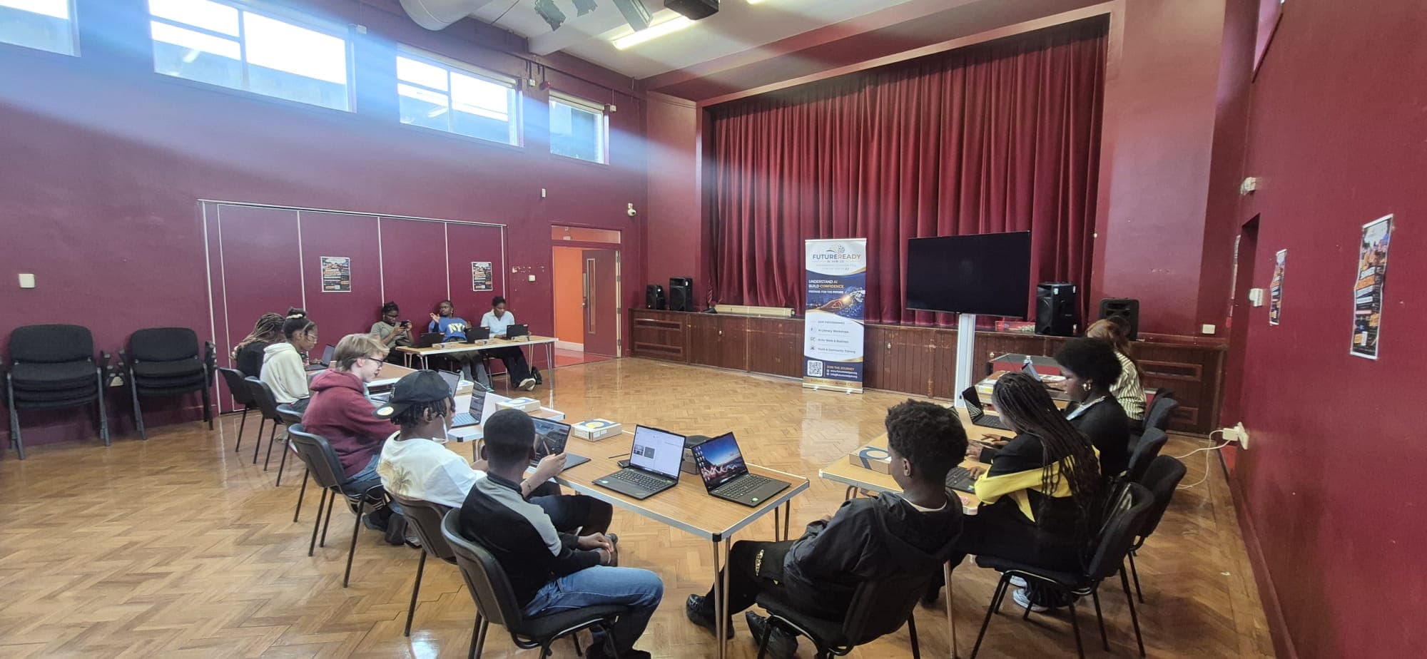Participants working on laptops during a FutureReady AI workshop