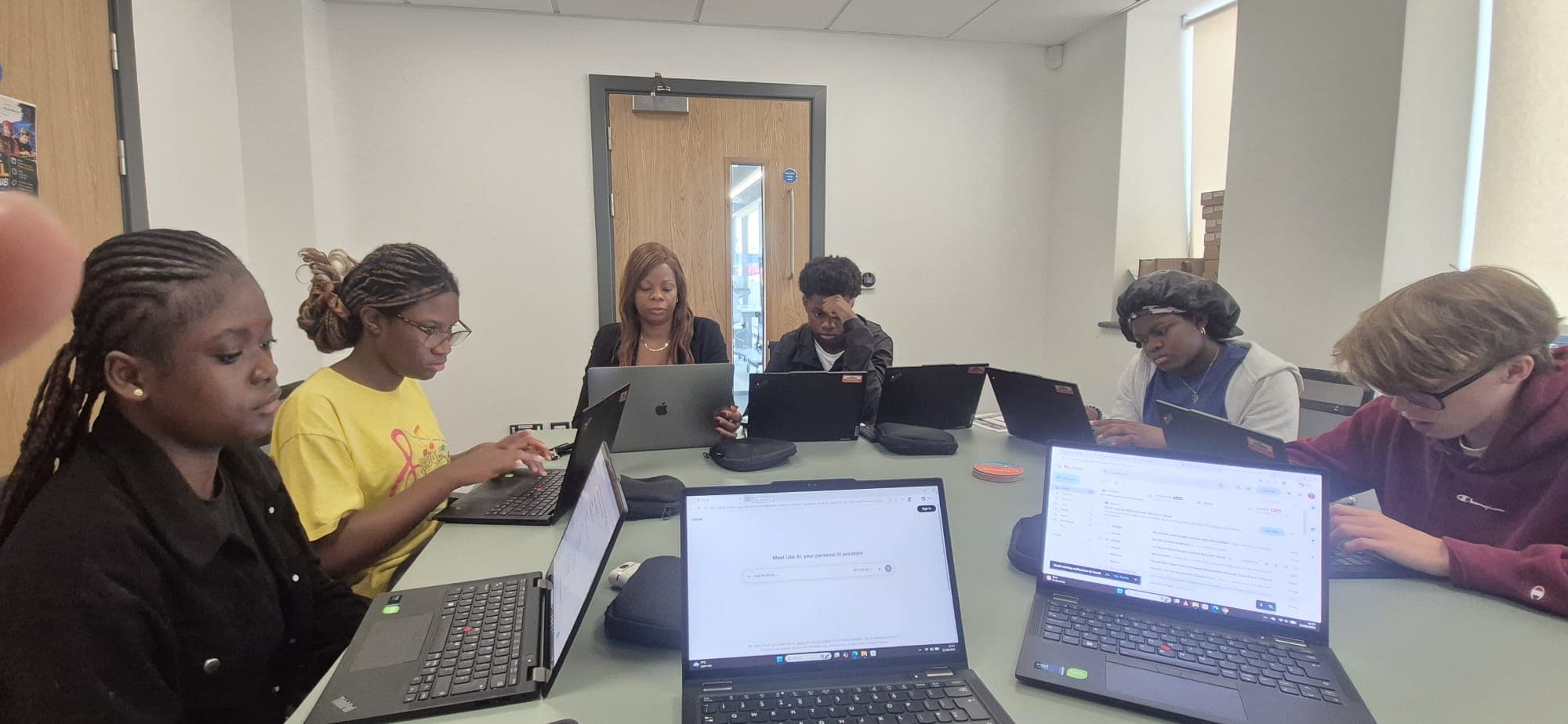 Participants working on their AI projects at the digital hub